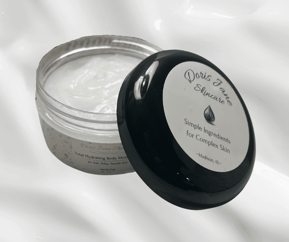 Open jar of skincare cream with black lid, labeled 'Simple Ingredients for Complex Skin'.